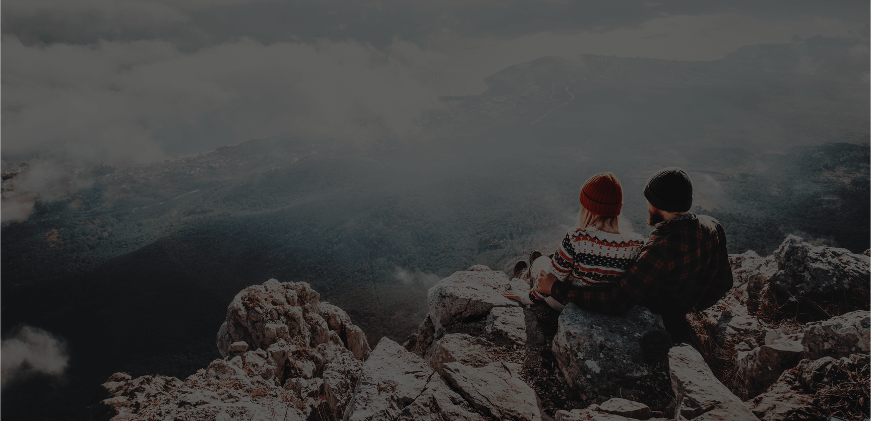 Couple sitting on a mountain